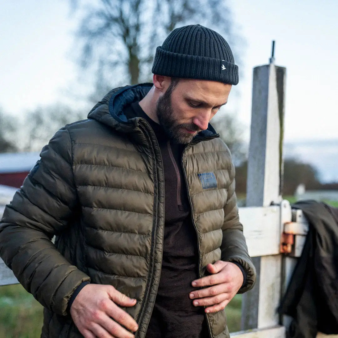 Man in a puffy jacket and knit beanie wearing the Seeland Fahrenheit Jacket