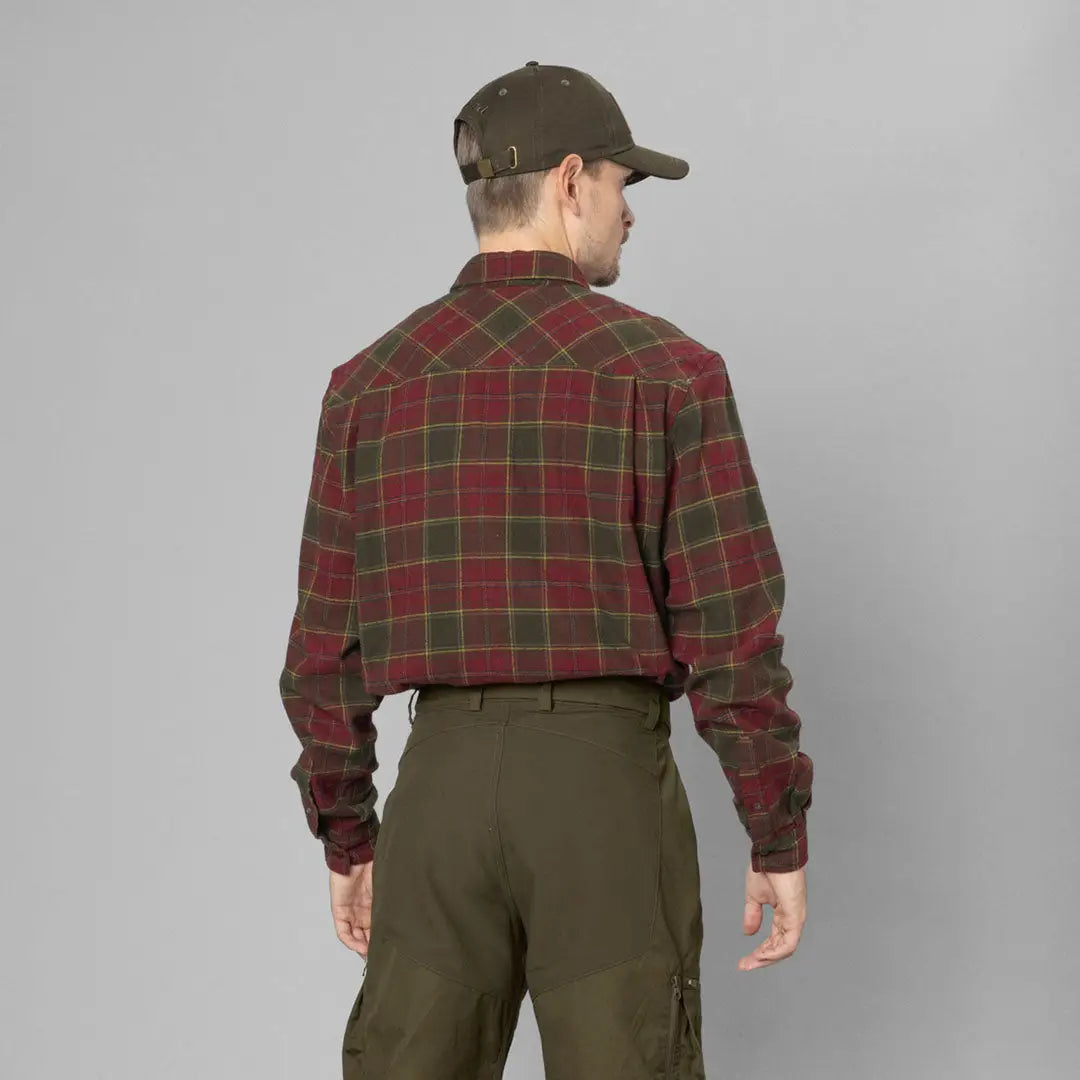 Man in a plaid flannel shirt and dark cap showcasing Seeland Glen Flannel Shirt