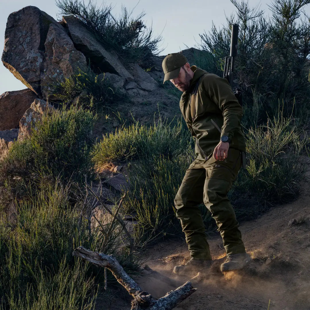 Person walking a dusty trail in rugged terrain wearing Seeland Hawker Shell II Jacket