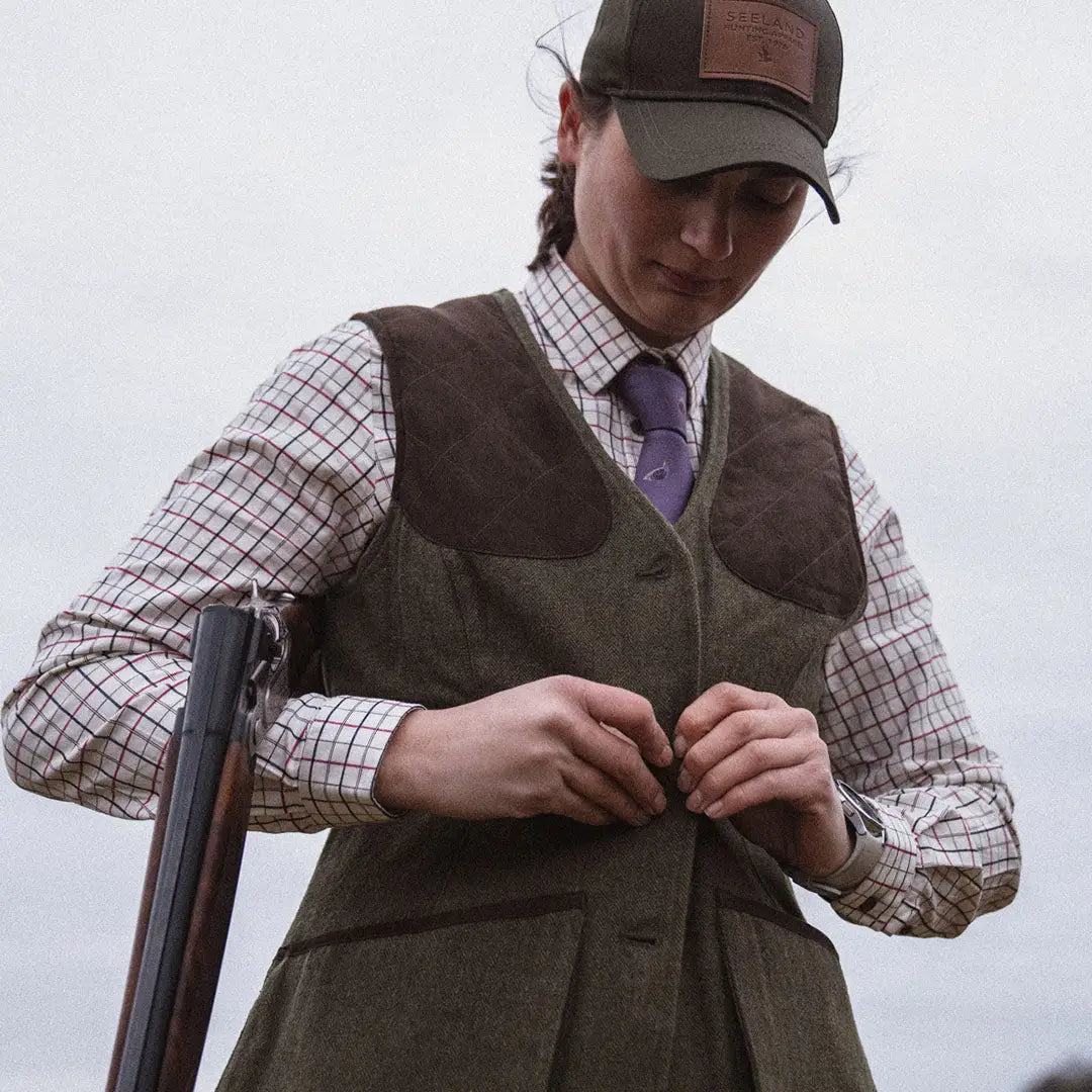 Man in Seeland Hillside Harriet Waistcoat with shotgun and traditional hunting gear