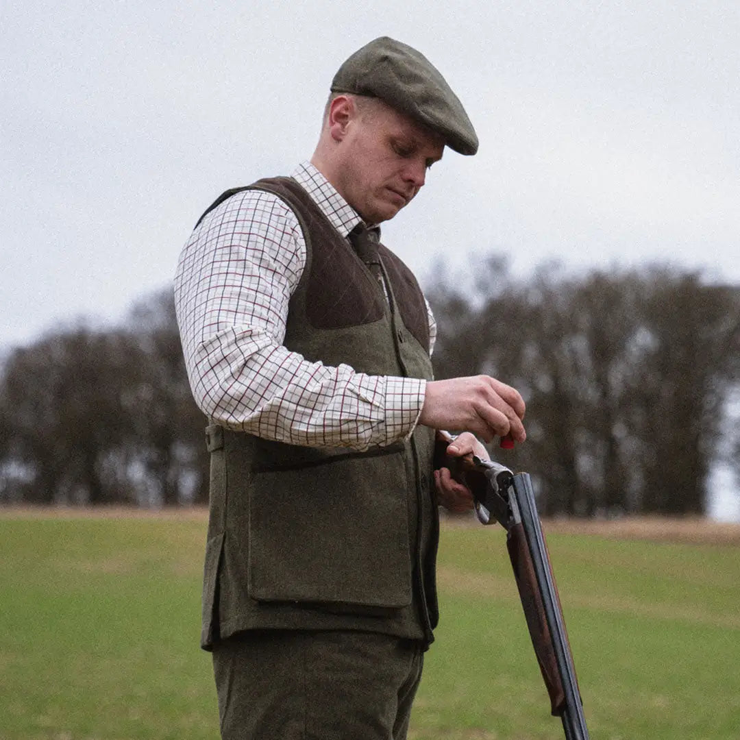 Man in Seeland Hillside Waistcoat with shotgun, showcasing traditional hunting style