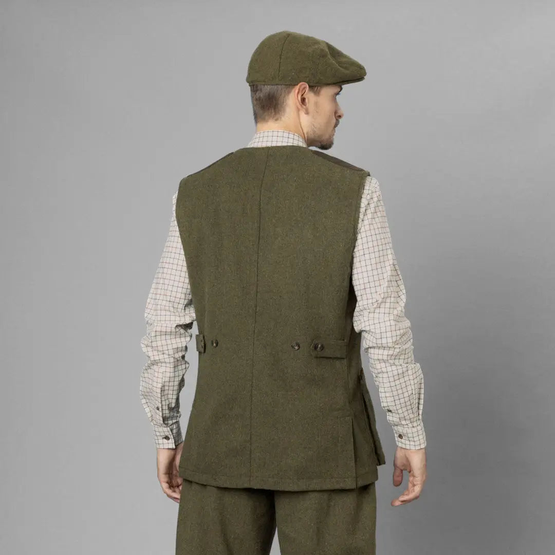 Man in green tweed Seeland Hillside Waistcoat and matching cap, seen from behind