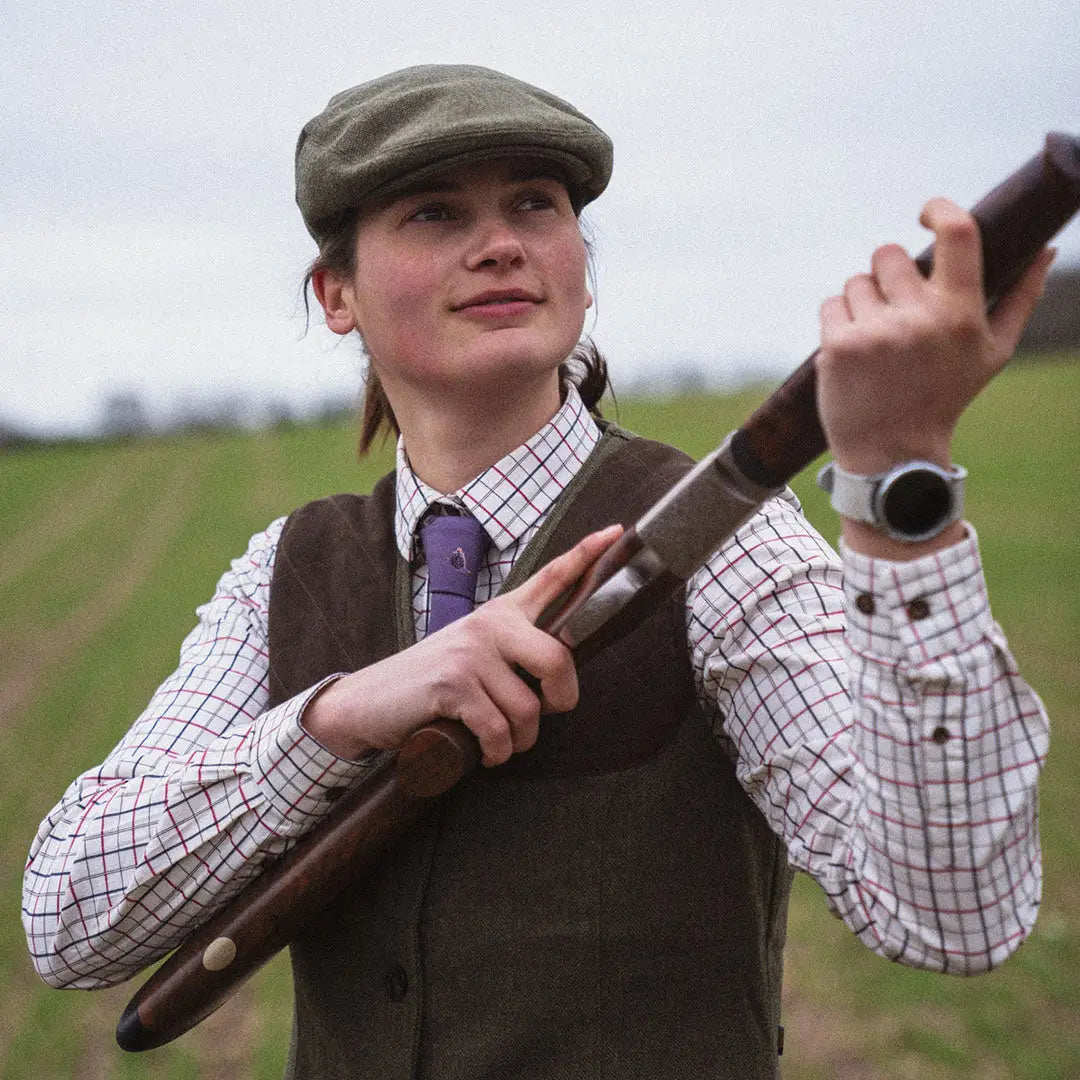 Person in countryside attire with shotgun wearing a stylish Kerry Shooting Shirt