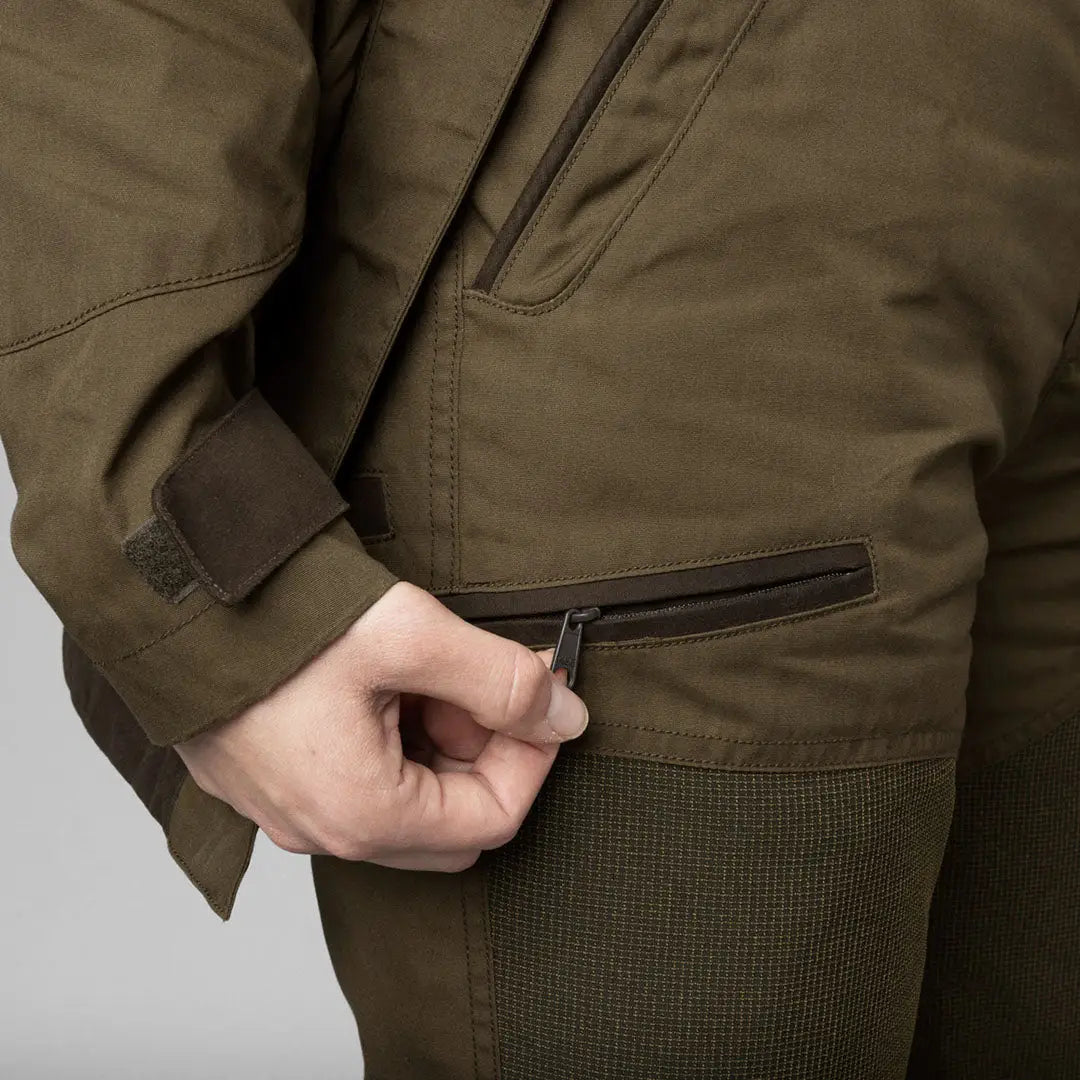 Olive green jacket and a hand reaching into the pocket of Seeland Key-Point Kora Ladies Trousers