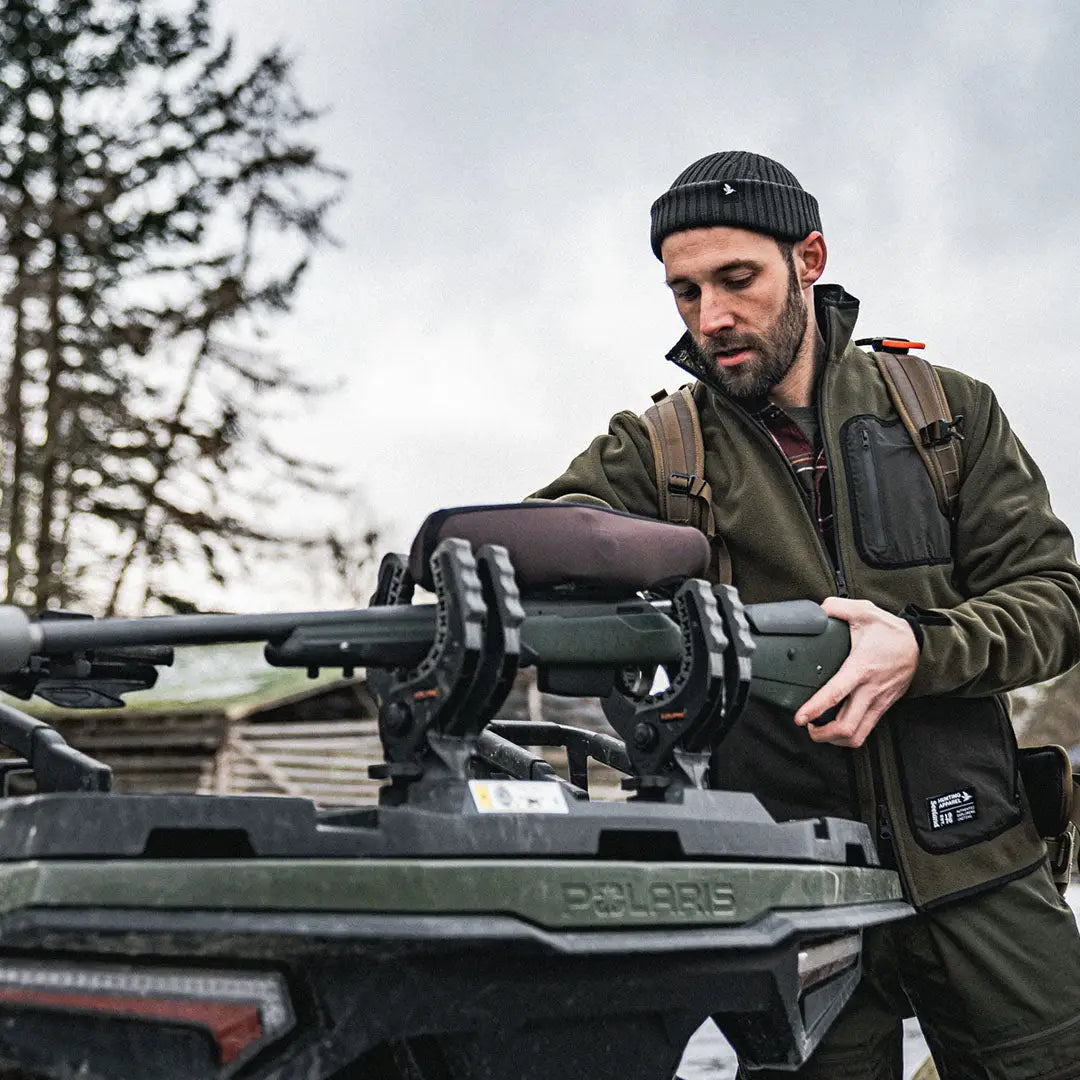 Man handling a drone on a vehicle while wearing Seeland Rogue Reversible Fleece