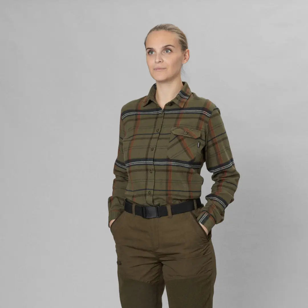 Woman in green plaid Seeland Skye flannel shirt and brown pants, perfect for country clothing