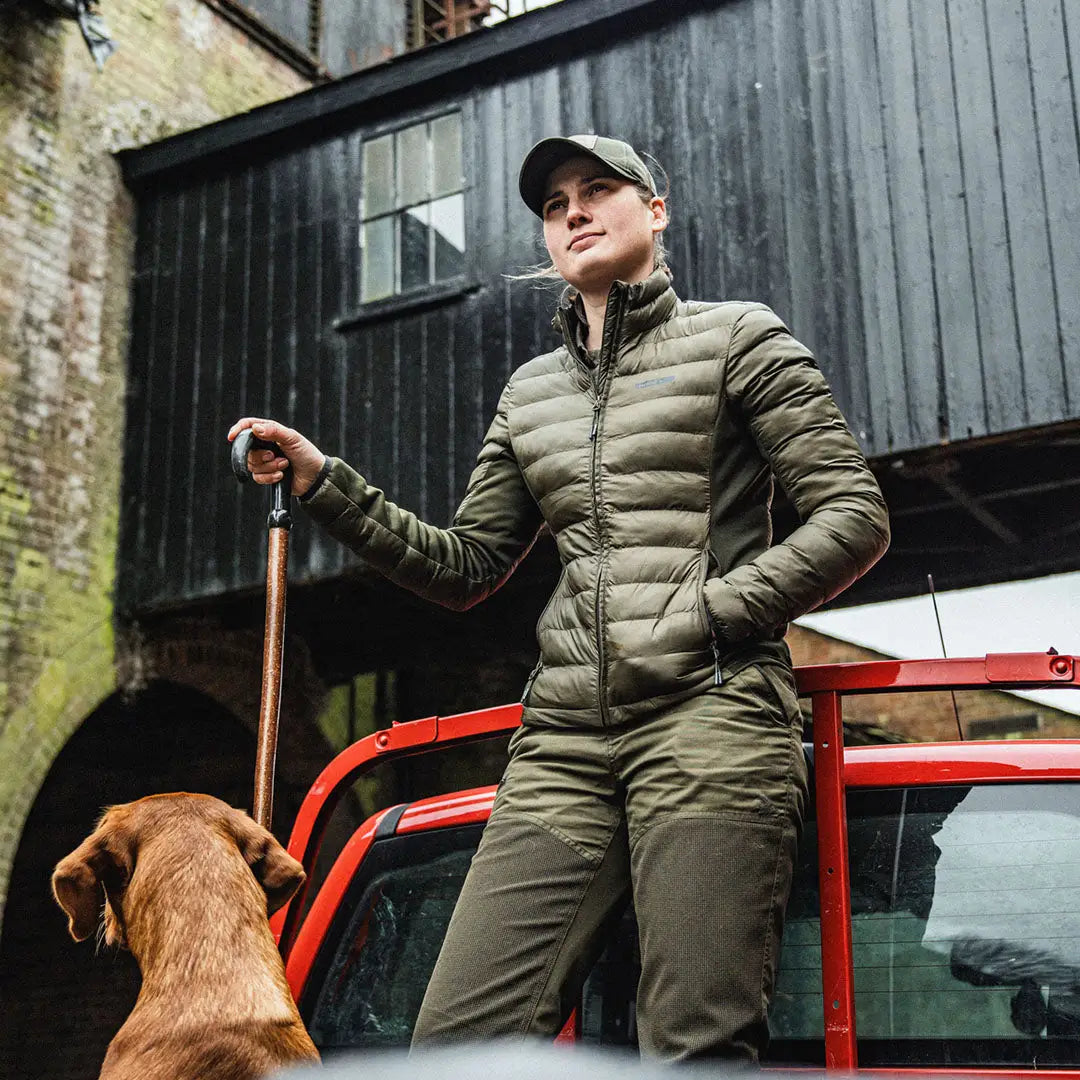 Woman in olive green Seeland Therma Jacket with a dog, perfect for country clothing and hunting