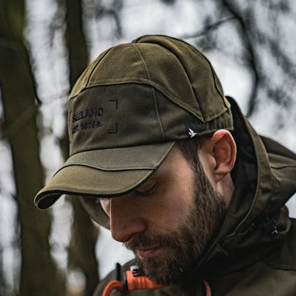 Military-style olive green Seeland Trax Cap with text on the side