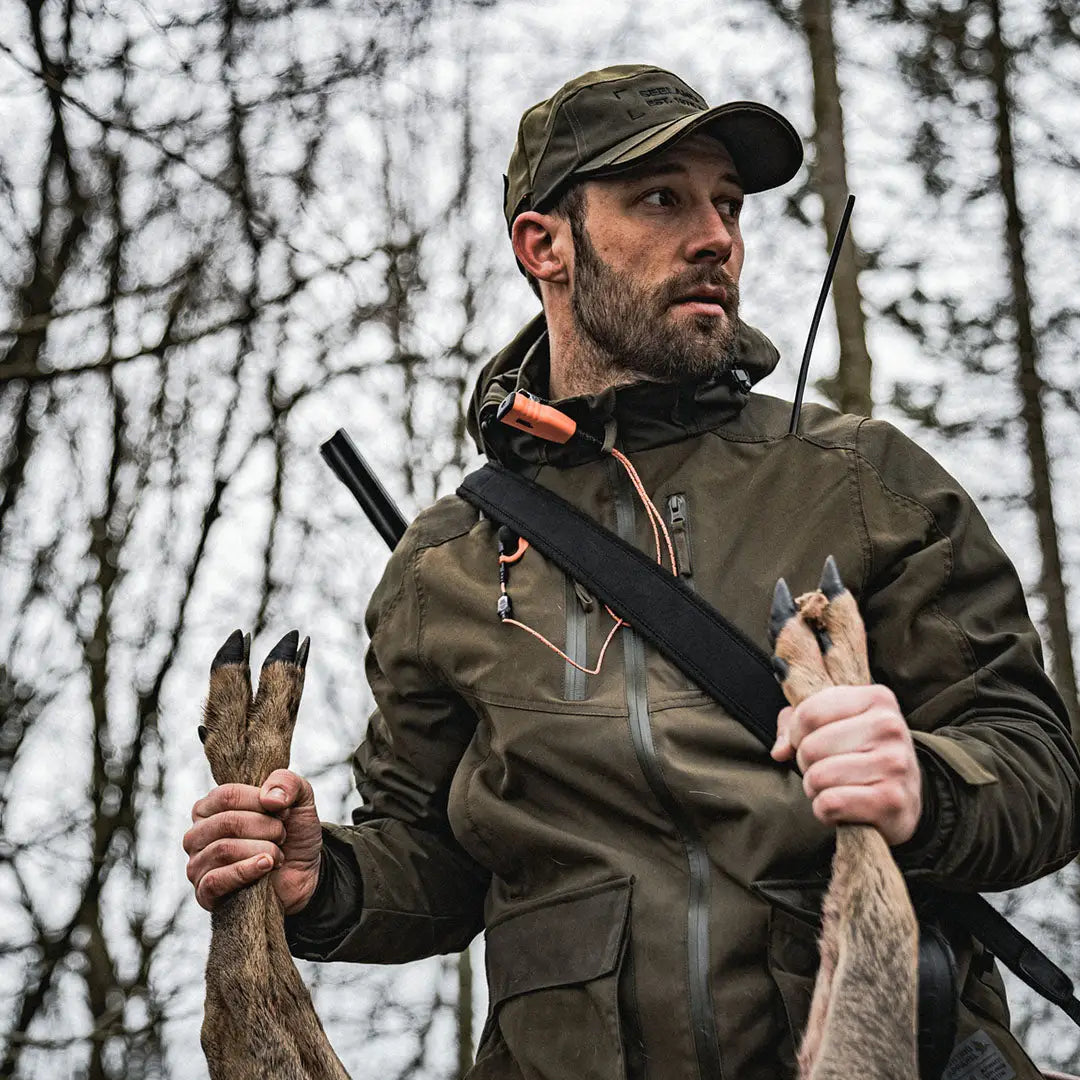 Bearded man in hunting gear with antlers and rifle wearing Seeland Trax Jacket