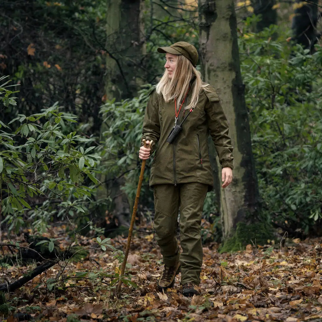 Person in Seeland Women’s Avail Jacket enjoying the outdoors while hiking in the forest