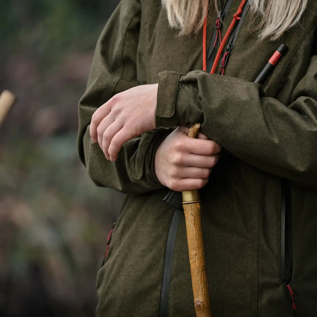 Wooden walking stick held by hands in Seeland Womens Avail Jacket for outdoors lovers