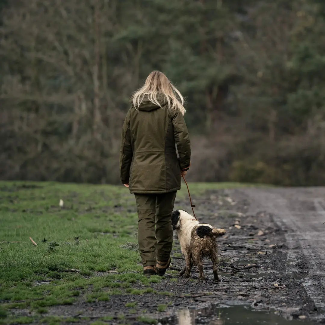 Woman wearing Seeland Womens Avail Jacket walking dog outdoors on muddy path