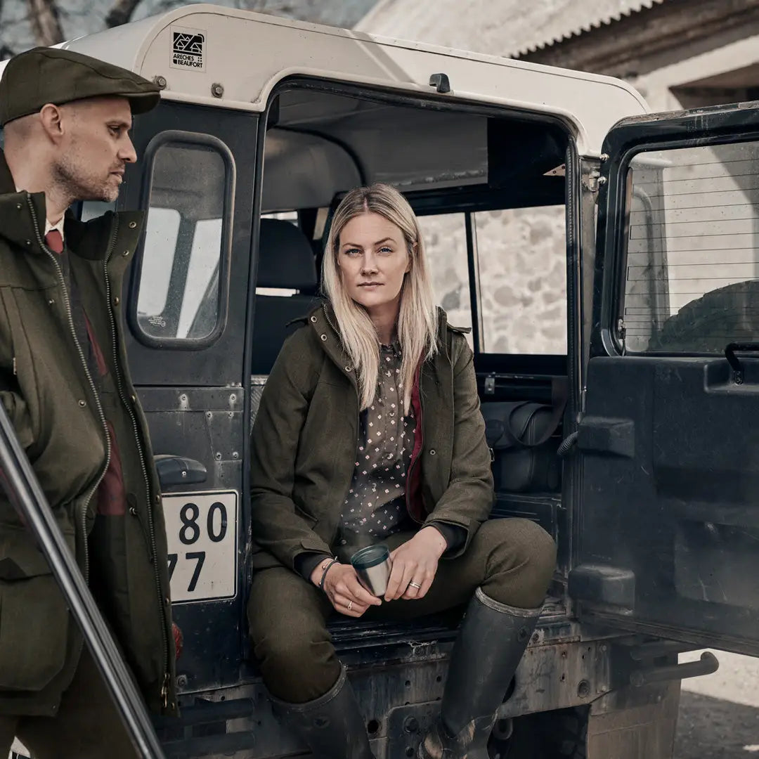 Military-style vehicle with two people inside showcasing Seeland Woodcock Advanced Trousers