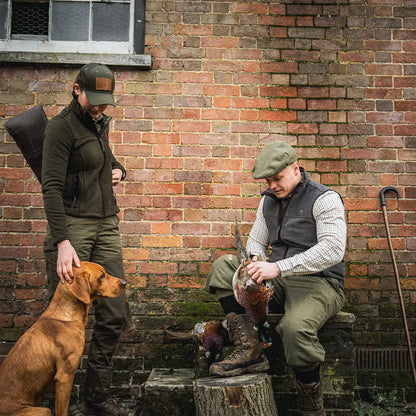 Two men in hunting gear with a dog wearing the Seeland Ivy Fleece Jacket