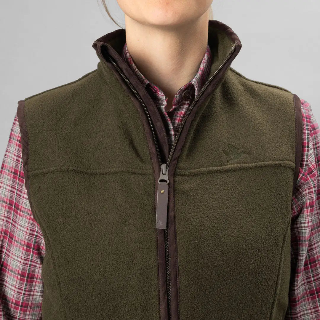 Olive green Ivy Fleece Waistcoat over a stylish plaid shirt for a cozy look