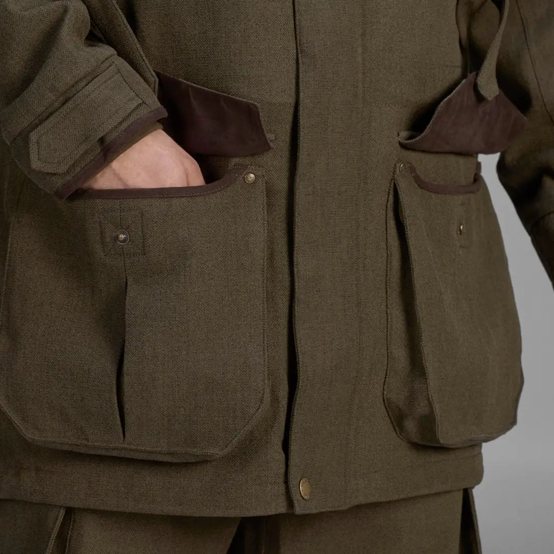 Olive green Seeland Woodcock Advanced Jacket with pockets and hand in one pocket