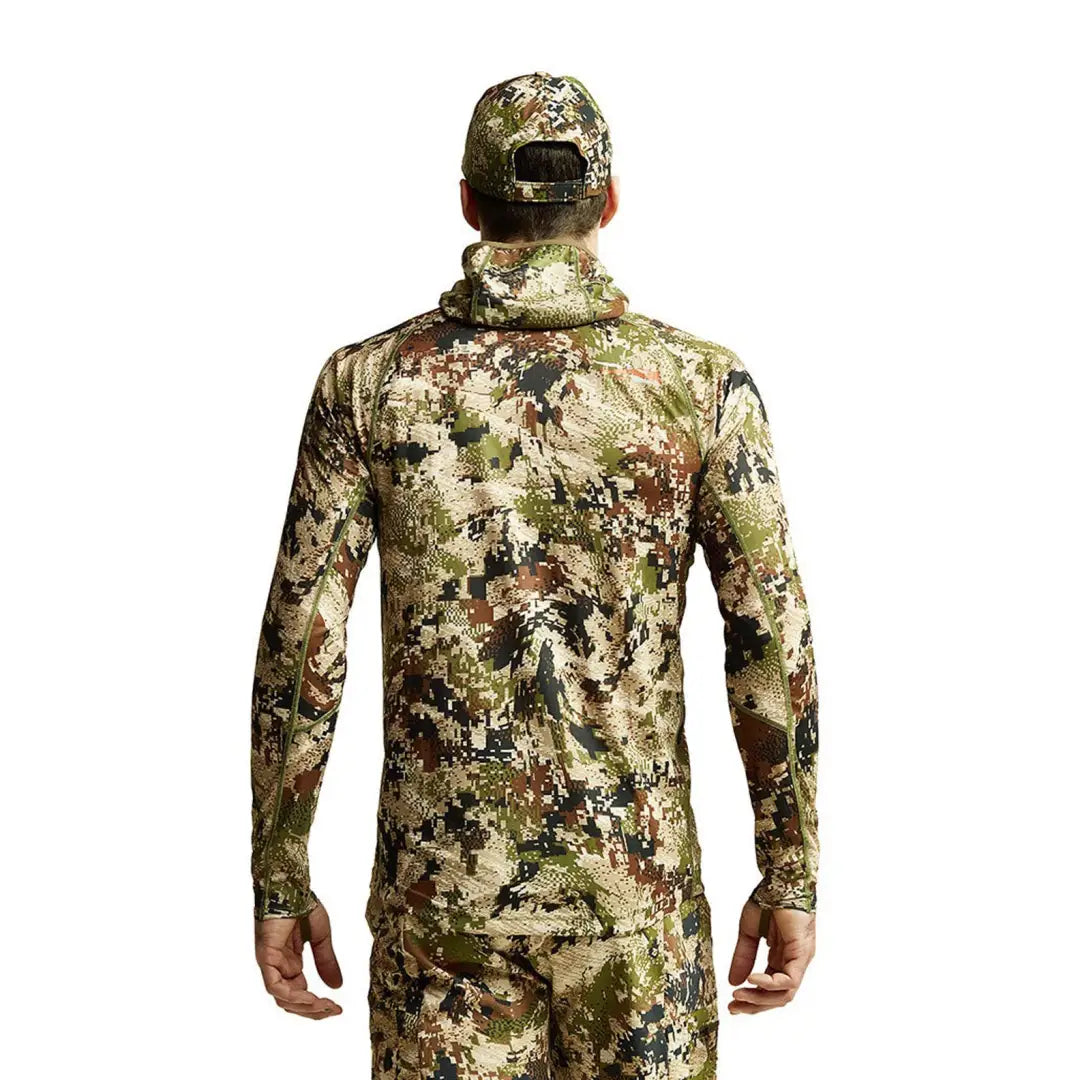 Camouflage hunting outfit and cap from behind featuring Sitka Core Lightweight Hoody