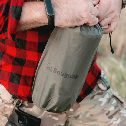 Olive green Snugpak Self-Inflating Midi Mat held by a person in a plaid shirt