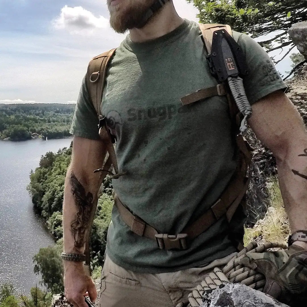 Person in Snugpak T-Shirt on cliff, enjoying the outdoors by a serene lake