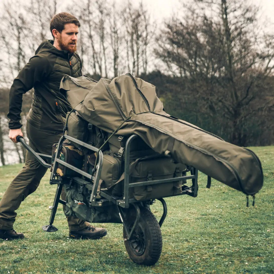 Wheeled cart covered in green tarp showcasing Speero 5/6 Rod Holdall for country clothing