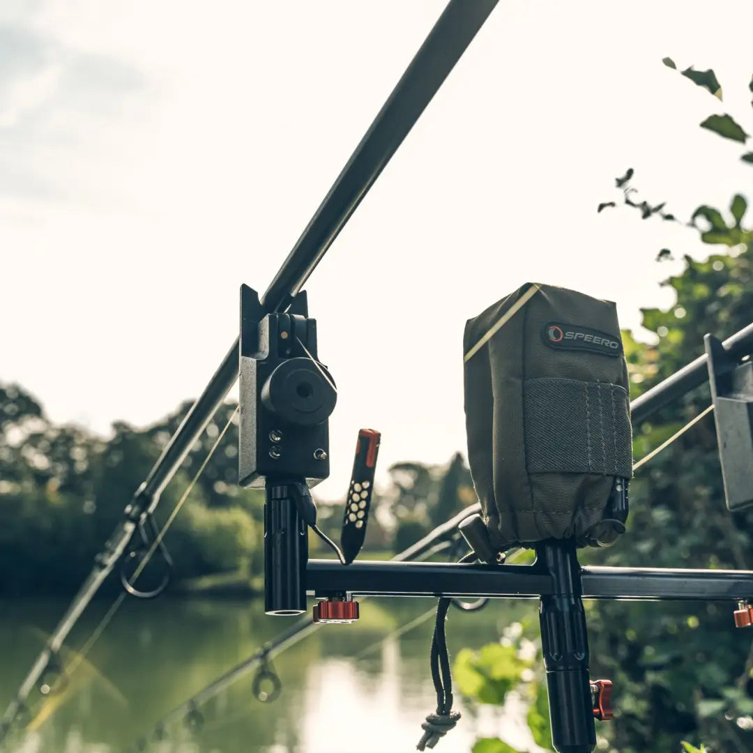 Fishing rod with Speero Alarm Pouch and electronic bite alarm by the water