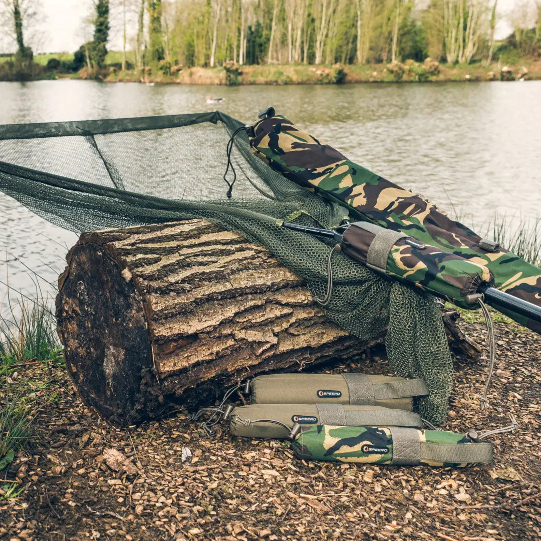 Fishing net and gear on a log by water with Speero Net Retention Float