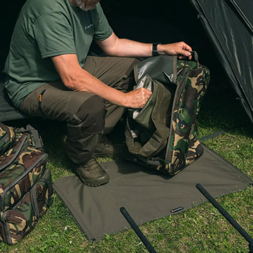 Camouflage-patterned Speero Wader Bag being packed for outdoor adventures