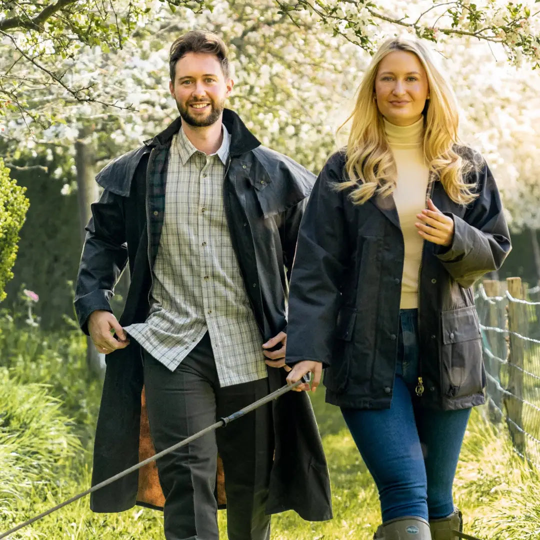 Couple enjoying spring outdoors in a stylish Wax Stockman Coat