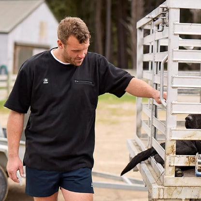 Man in black shirt and blue shorts wearing Swanndri Cotton Rugby Shorts