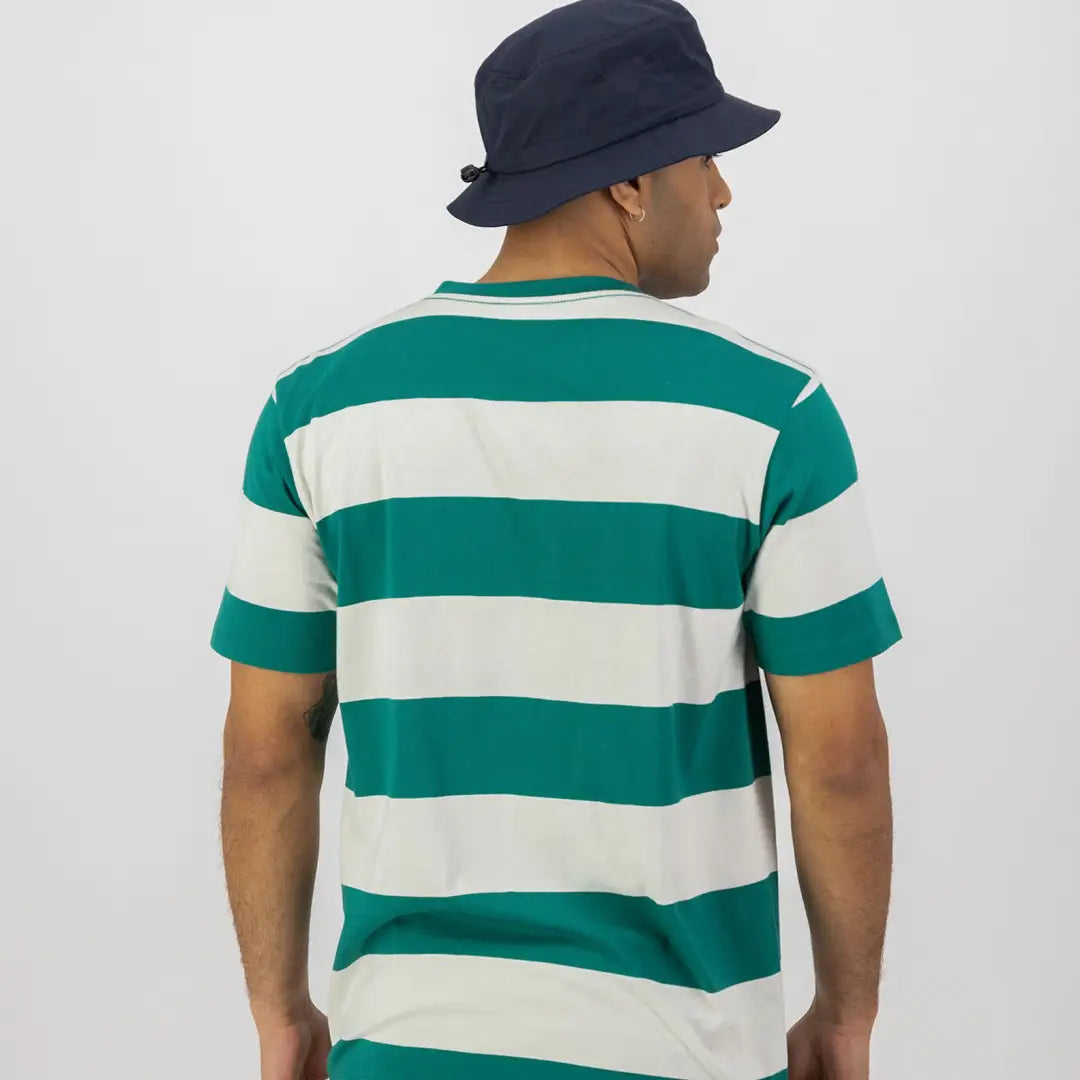 Man in a green and white striped shirt rocking a navy blue bucket hat for hunting