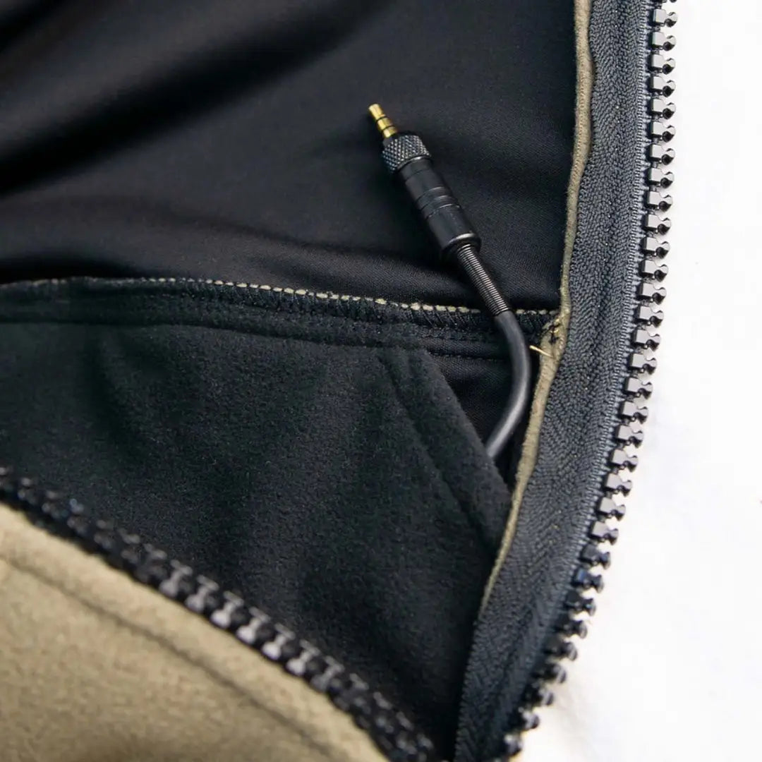 Audio cable connector peeking from a zippered compartment in Swazi’s legendary 350gsm fleece