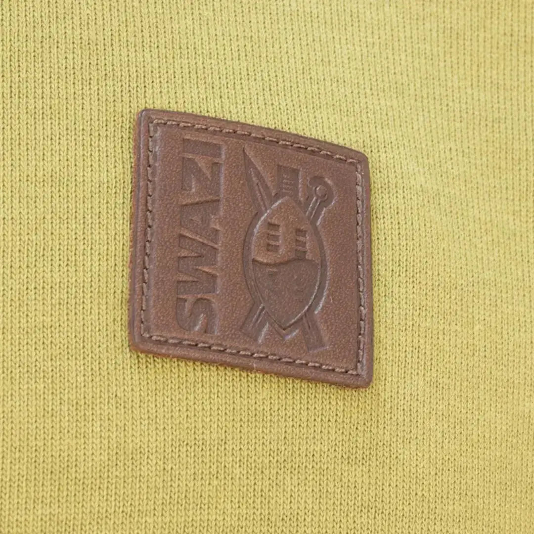 Brown leather patch with SWIMS logo on a yellow Swazi Rugger Jersey