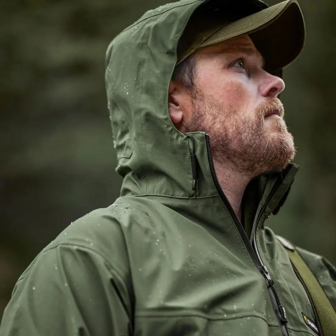 Bearded man in a green Swazi Sentinel Ultralight Jacket perfect for country clothing and hunting