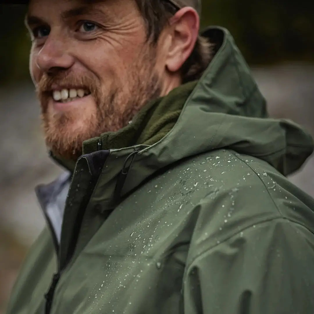 Smiling bearded man in the Swazi Sentinel Ultralight Jacket for country clothing adventures