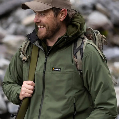 Smiling bearded man in a green Swazi Sentinel Ultralight Jacket for country clothing