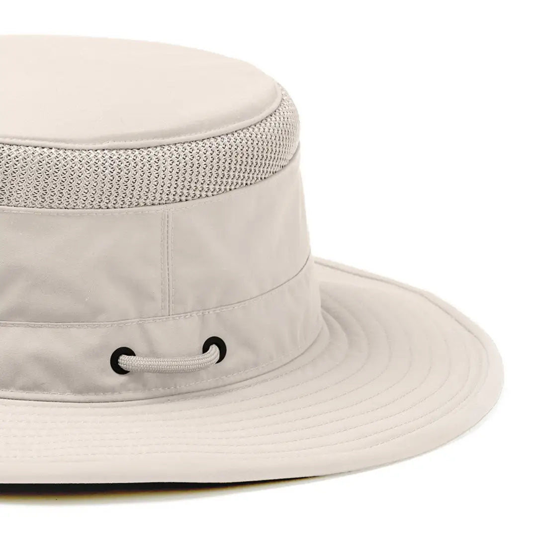 Beige wide-brimmed Tilley’s Airflo Boonie hat with mesh band and drawstring