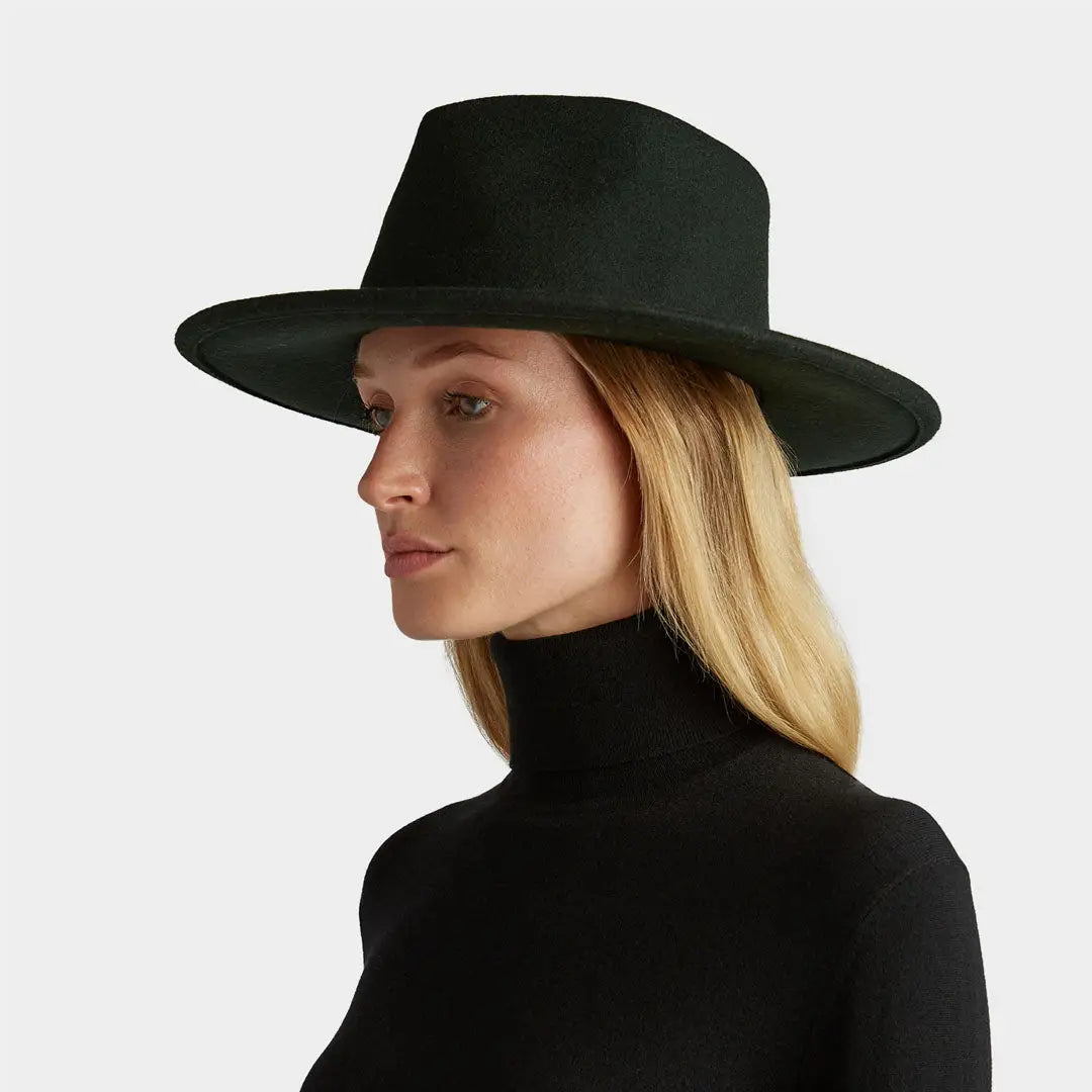 Wide-brimmed black Jasper Hat on a blonde, perfect for country clothing and hunting