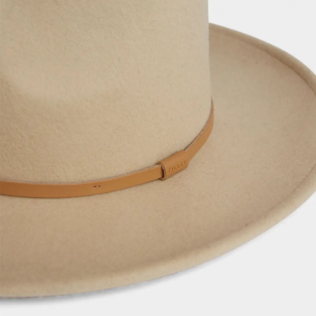 Beige wide-brimmed felt Tilley New Jasper Hat with tan leather band for country clothing