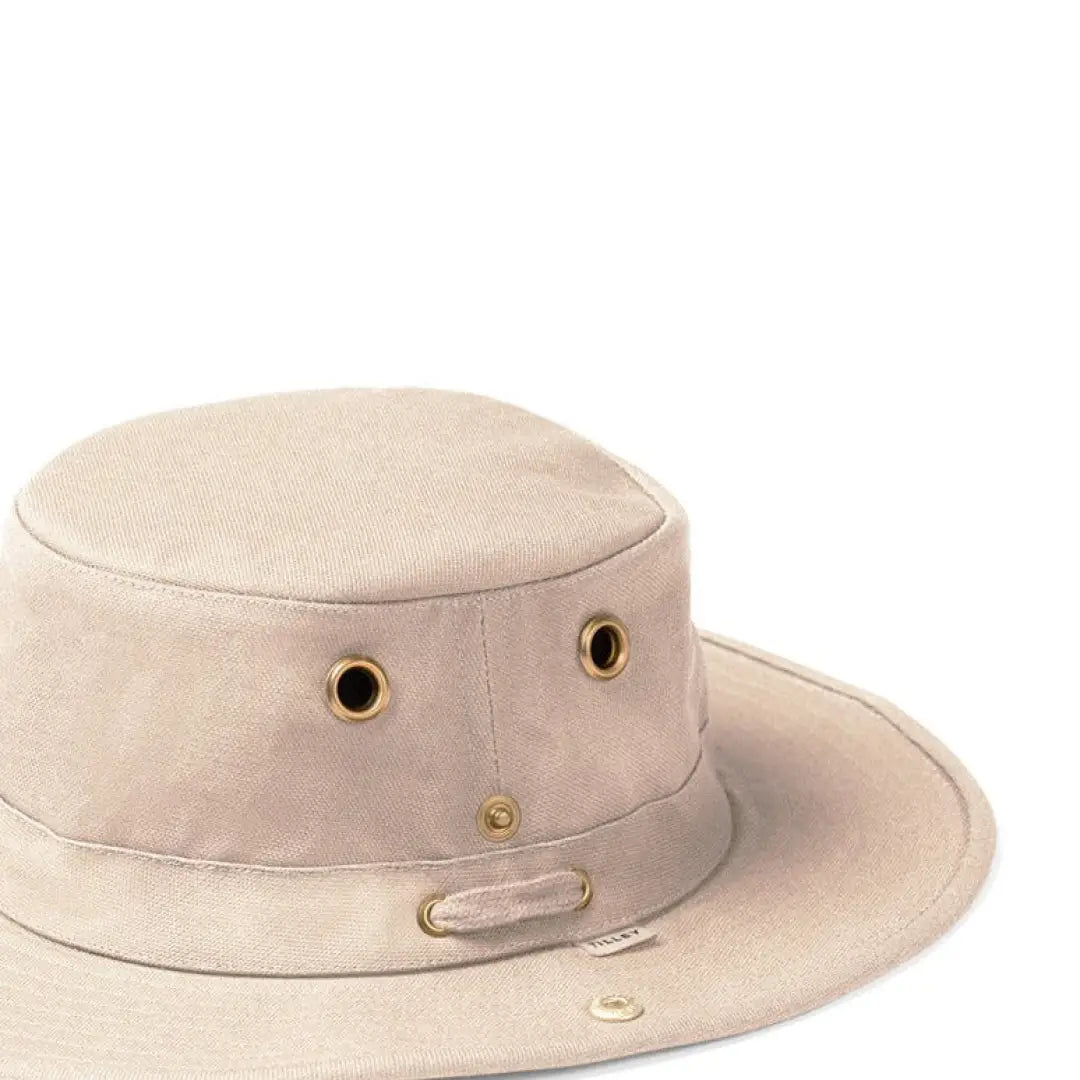 Beige Tilley TH5 Hemp Hat with sloped brim design, brass eyelets, and chin strap