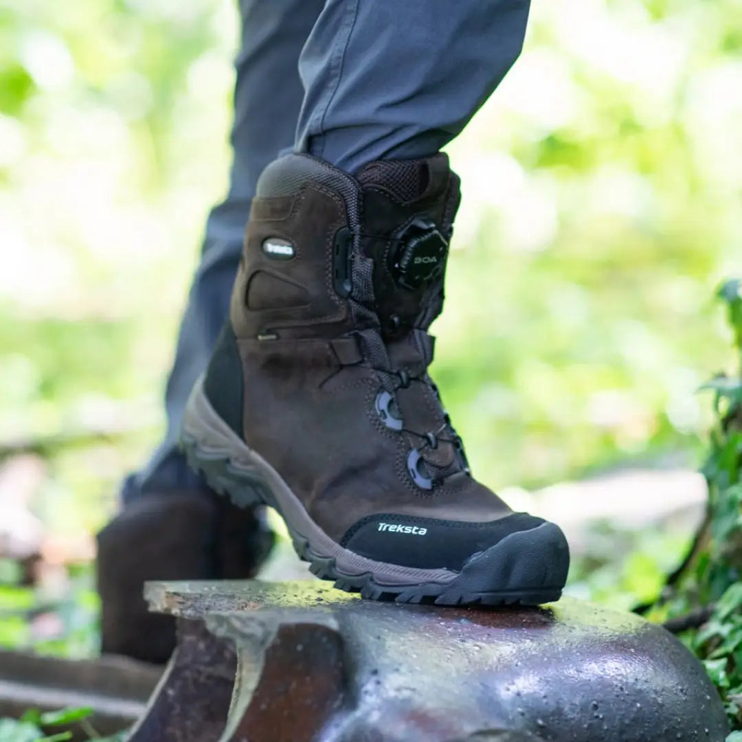 Rugged brown Treksta Winchester 6’’ BOA GTX Hunting Boot on rocky surface with Gore-Tex waterproof leather