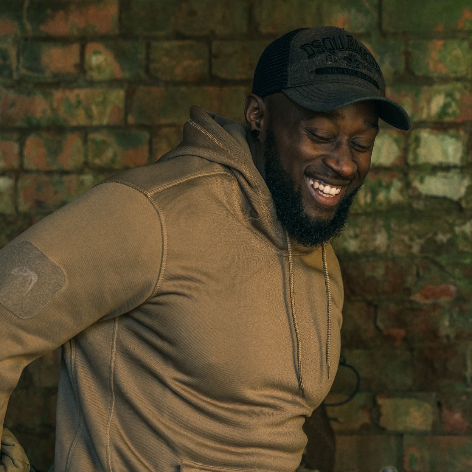 Smiling man wearing a tan Viper Armour Hoodie looking stylish and comfy