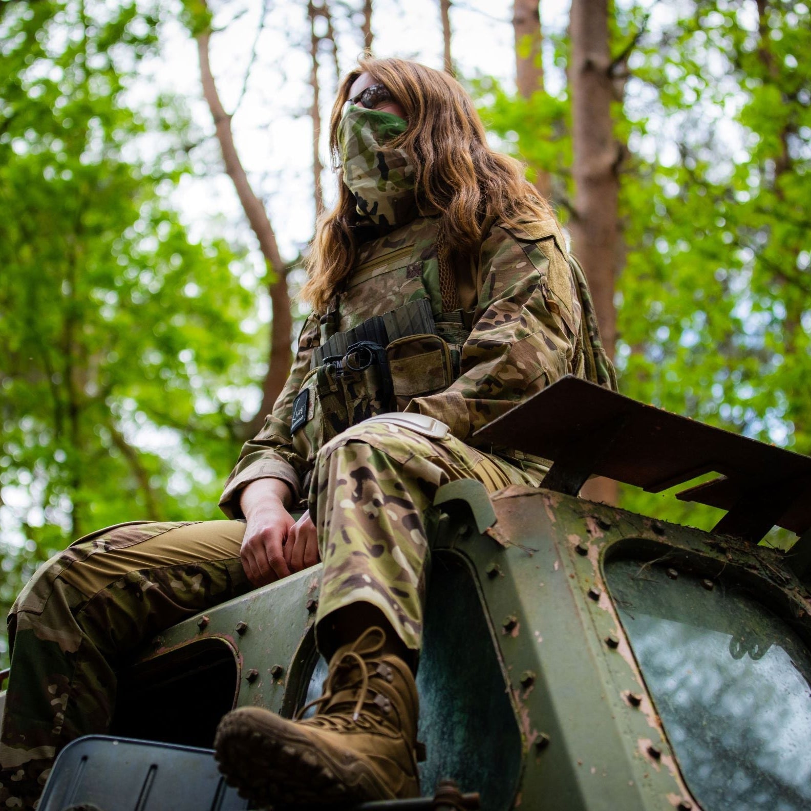 Camouflaged soldier on armored vehicle wearing Viper Tactical Snood as neck gaiter