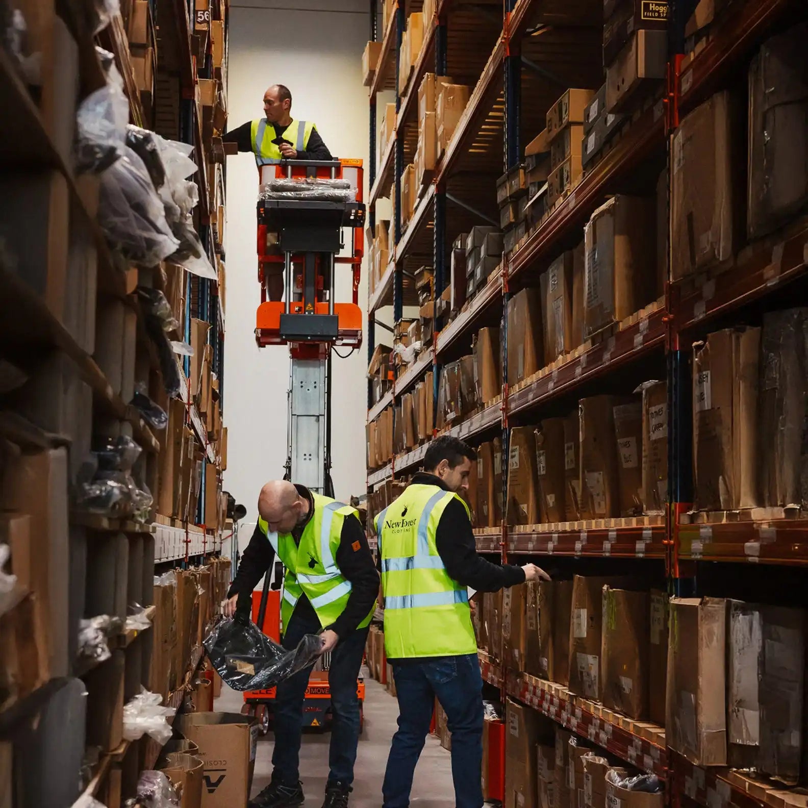 Warehouse workers in safety vests.