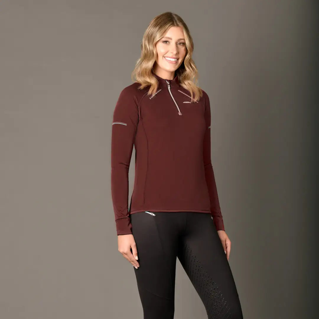 Woman in a burgundy WeatherBeeta Victoria Premium Thermal Baselayer Top and black pants